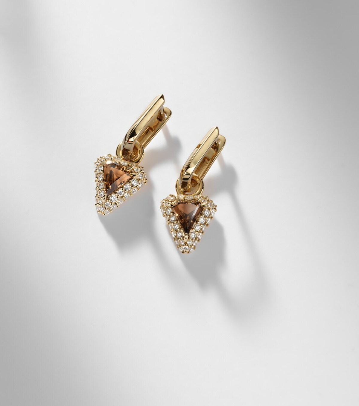 Stone and Strand Power 14kt gold huggie earrings with diamonds and garnet