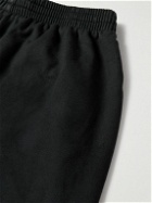 Balenciaga - Wide-Leg Distressed Logo-Appliquéd Cotton-Jersey Sweatpants - Black