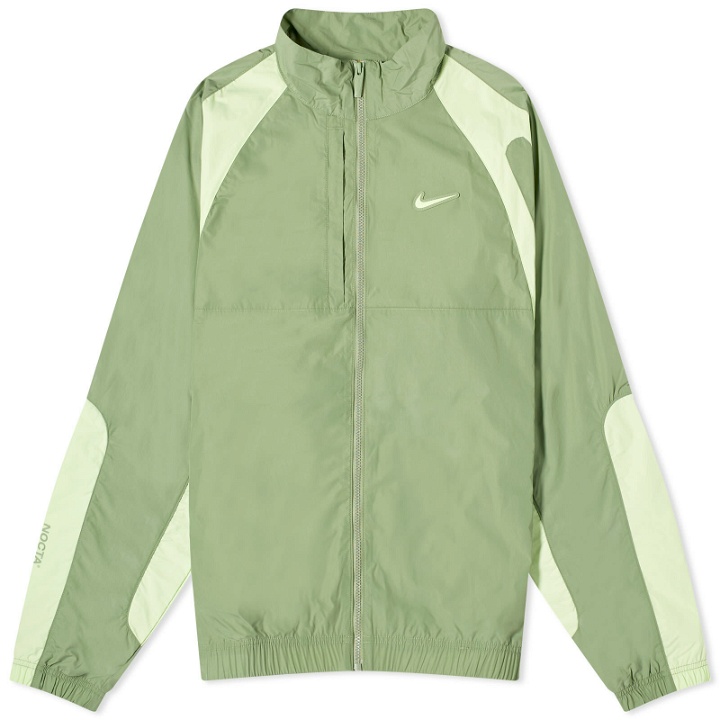 Photo: Nike x NOCTA Cardinal Stock Woven Trek Jacket in Oil Green/Light Liquid Lime