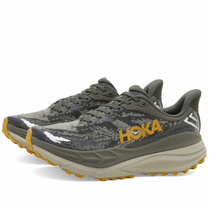 Photo: Hoka One One Men's Stinson 7 Sneakers in Olive Haze/Forest Cover