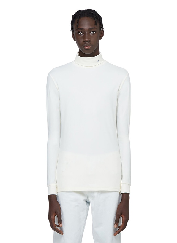 Photo: Pleats Please Issey Miyake R-Embroidered Turtleneck Top