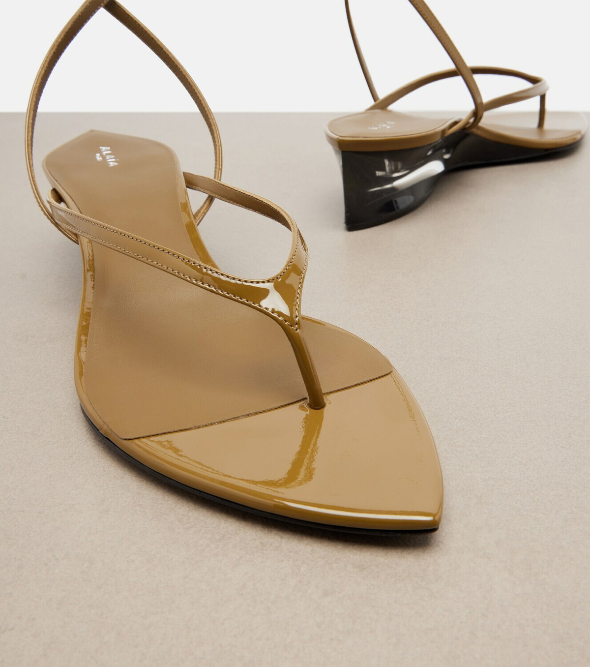 Alaïa Invisible patent leather wedge thong sandals