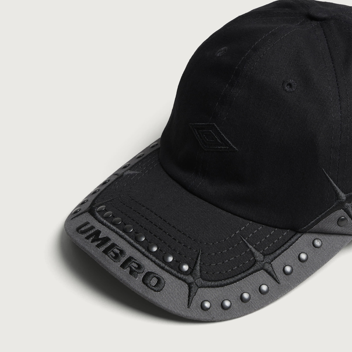 Umbro by Slam Jam Men's Spikes Stud Cap in Black