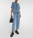 Ganni Striped bow-trimmed peplum denim blouse
