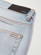 AMIRI - Skinny-Fit Logo-Print Distressed Jeans - Blue
