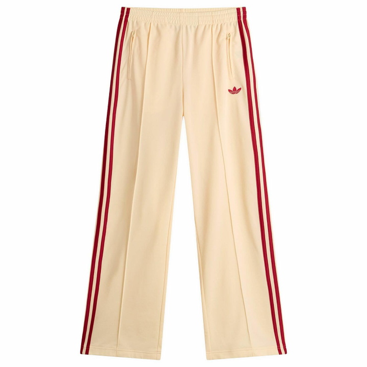 Photo: Adidas Women's Firebird Loose Track Pant in Warm Vanilla/Team Victory Red