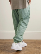 FEAR OF GOD ESSENTIALS - Tapered Logo-Appliquéd Padded Stretch-Shell Drawstring Trousers - Green