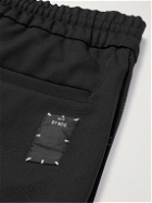 MCQ - Tapered Logo-Appliquéd Pintucked Stretch-Jersey Sweatpants - Black