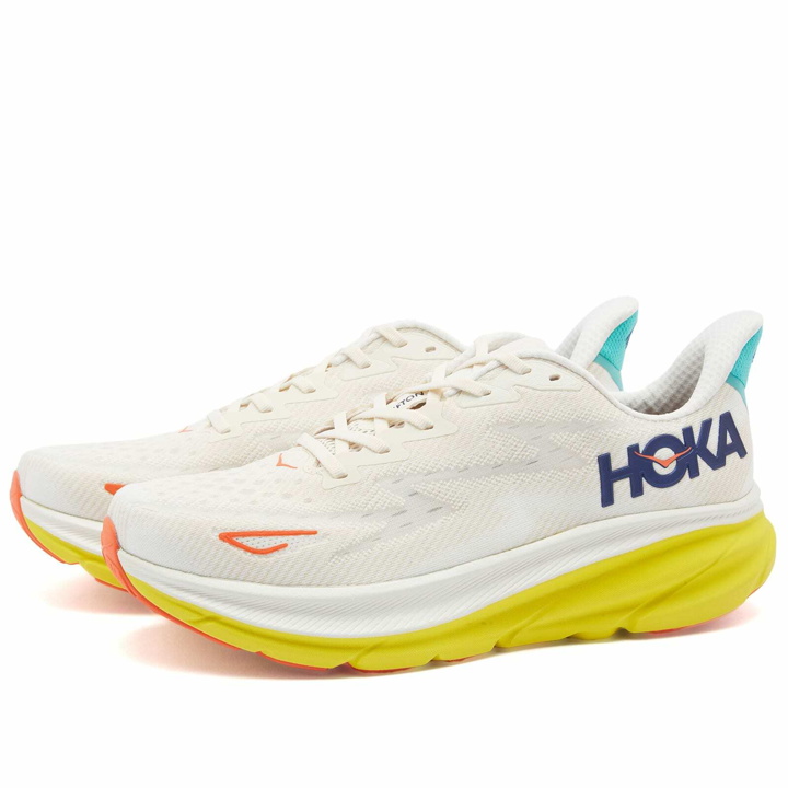 Photo: Hoka One One Men's Clifton 9 Sneakers in Eggnog/Passion Fruit