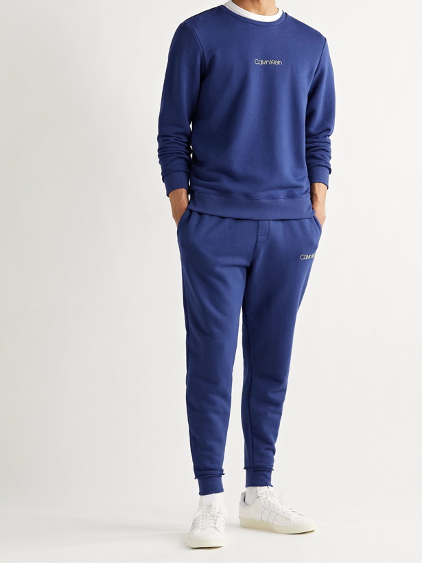 Photo: Calvin Klein Underwear - Tapered Logo-Print Loopback Cotton-Blend Jersey Sweatpants - Blue