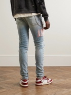 AMIRI - Skinny-Fit Logo-Appliquéd Distressed Jeans - Blue
