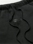 FEAR OF GOD ESSENTIALS - Tapered Logo-Flocked Cotton-Blend Jersey Sweatpants - Black
