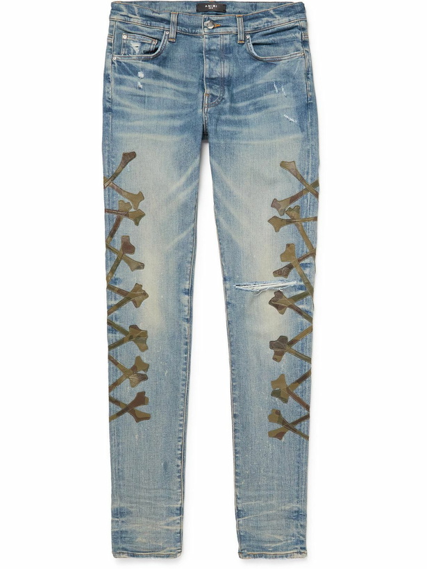 Photo: AMIRI - Skinny-Fit Camouflage-Print Leather-Appliquéd Jeans - Blue