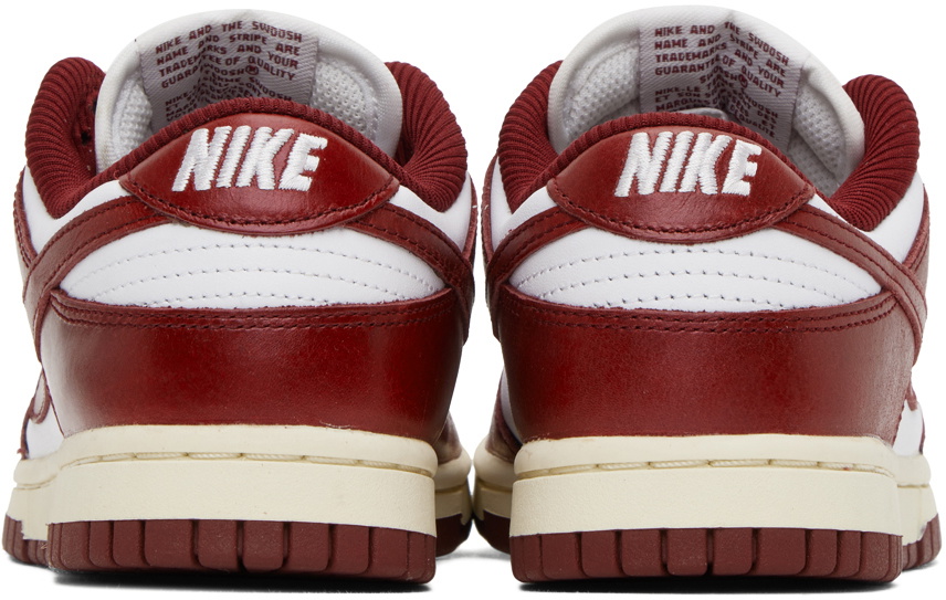 white nike sneakers with red swoosh