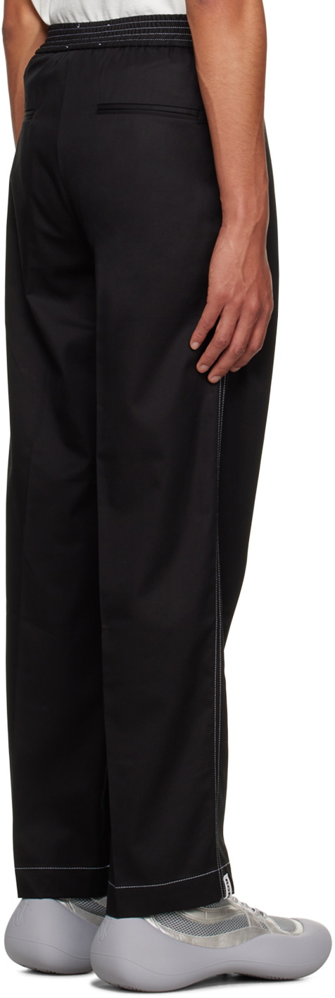 Full length darted black trousers