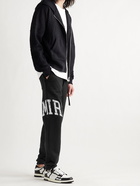 AMIRI - Slim-Fit Tapered Logo-Appliquéd Loopback Cotton-Jersey Sweatpants - Black